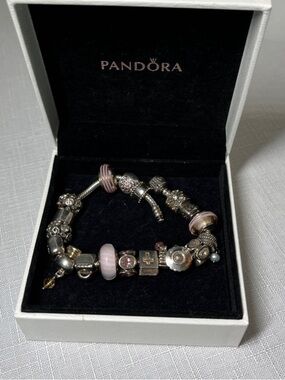 Pandora bracelet. 18 pandora beads. 1 SS bead. 8”. Pink tones. Box in
Stunning!